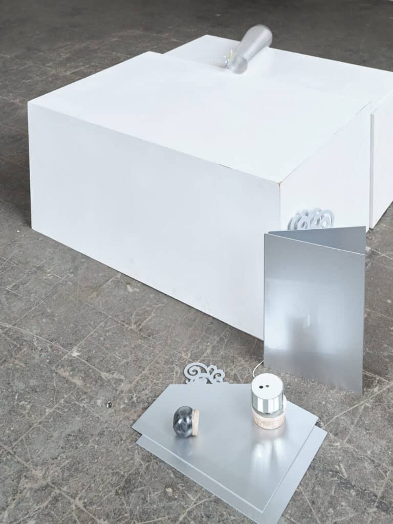 Foto: Nahaufnahme einer skulpturalen Installation mit weißen und silberfarbenen Objekten
