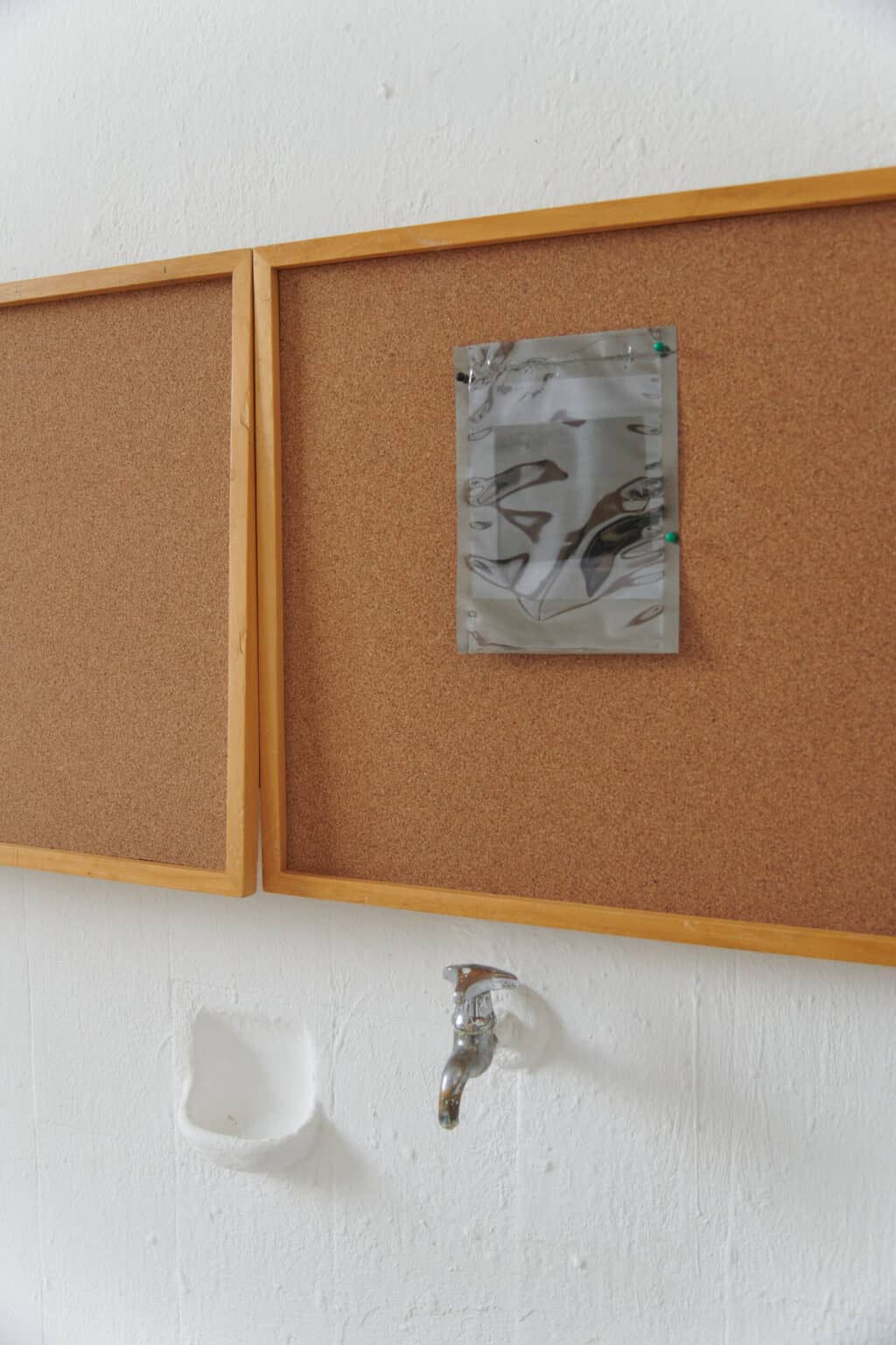 Foto: Nahaufnahme eines flachen Objektes, an das ein weiteres Objekt gepinnt ist.