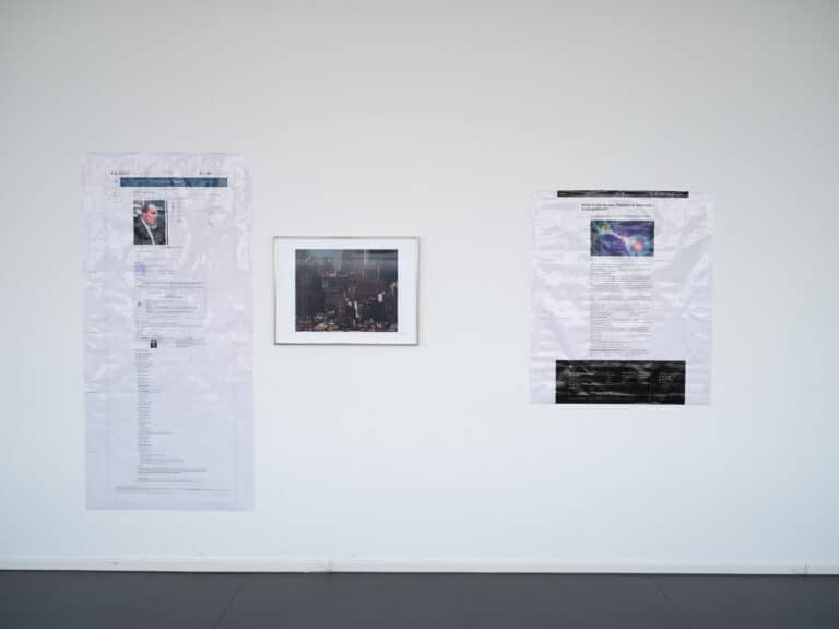 Foto: Detailaufnahme von zwei Drucken und einem gerahmten Bild auf einer weißen Wand.
