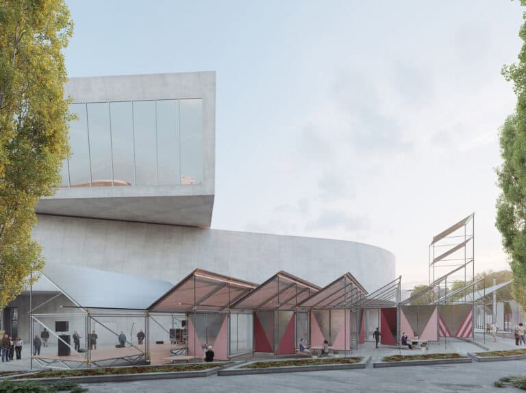 Ansicht eines Gebäudes, das aus zwei großen Sichtbeton-Formen besteht. Davor sind aus Leichtbauelementen zusammengesteckte Pavillons zu sehen.